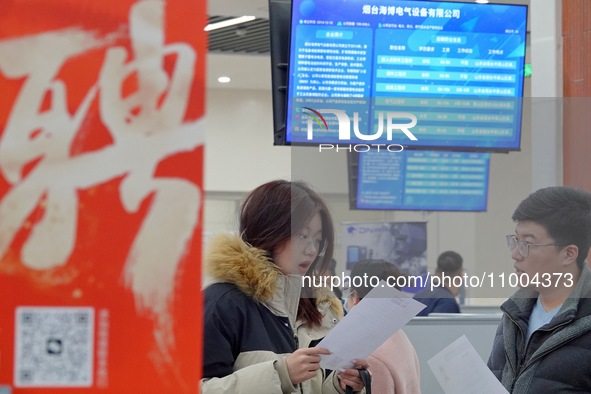 Job seekers are talking with employers at the 2024 job fair in Yantai, China, on February 18, 2024. In 2023, 12.44 million new urban jobs we...