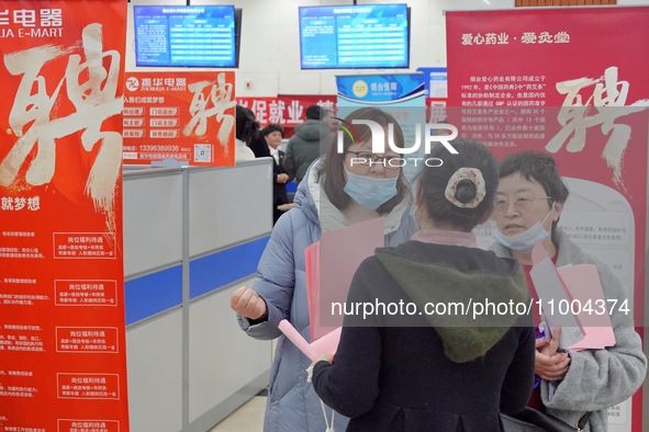 Job seekers are talking with employers at the 2024 job fair in Yantai, China, on February 18, 2024. In 2023, 12.44 million new urban jobs we...