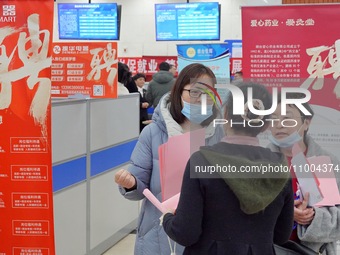 Job seekers are talking with employers at the 2024 job fair in Yantai, China, on February 18, 2024. In 2023, 12.44 million new urban jobs we...