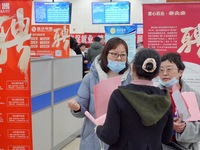 Job seekers are talking with employers at the 2024 job fair in Yantai, China, on February 18, 2024. In 2023, 12.44 million new urban jobs we...