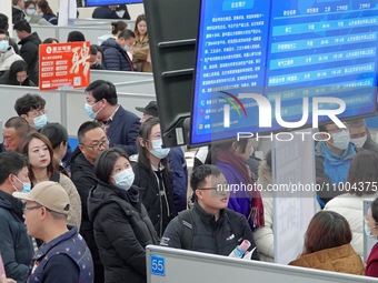 Job seekers are learning about employment information at the 2024 job fair in Yantai, China, on February 18, 2024. In 2023, 12.44 million ne...