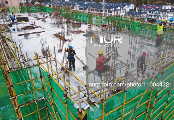 Workers are working at the construction site of a resettlement area project in Yuexi County, Anqing, China, on February 18, 2024. 