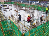 Workers are working at the construction site of a resettlement area project in Yuexi County, Anqing, China, on February 18, 2024. (