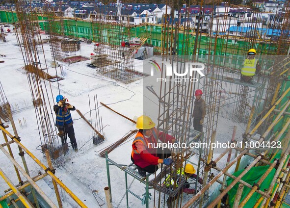 Workers are working at the construction site of a resettlement area project in Yuexi County, Anqing, China, on February 18, 2024. 