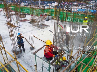 Workers are working at the construction site of a resettlement area project in Yuexi County, Anqing, China, on February 18, 2024. (