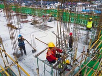 Workers are working at the construction site of a resettlement area project in Yuexi County, Anqing, China, on February 18, 2024. (