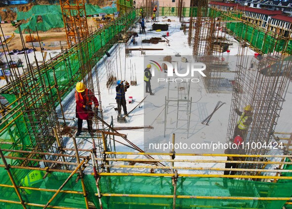 Workers are working at the construction site of a resettlement area project in Yuexi County, Anqing, China, on February 18, 2024. 