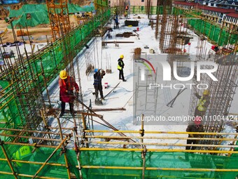 Workers are working at the construction site of a resettlement area project in Yuexi County, Anqing, China, on February 18, 2024. (