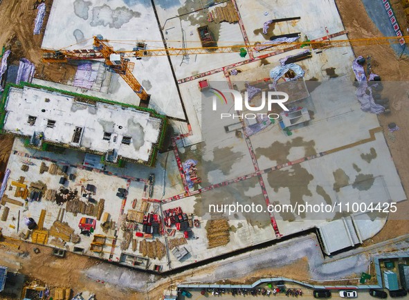 Workers are working at the construction site of a resettlement area project in Yuexi County, Anqing, China, on February 18, 2024. 