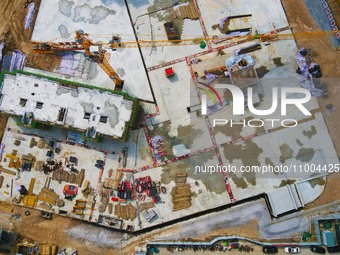 Workers are working at the construction site of a resettlement area project in Yuexi County, Anqing, China, on February 18, 2024. (