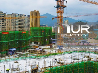 Workers are working at the construction site of a resettlement area project in Yuexi County, Anqing, China, on February 18, 2024. (