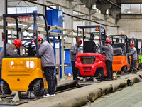 Workers are assembling at a workshop of a machinery and equipment manufacturing enterprise in Qingzhou, East China's Shandong province, on F...