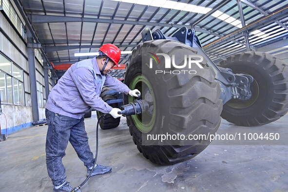 Workers are assembling at a workshop of a machinery and equipment manufacturing enterprise in Qingzhou, East China's Shandong province, on F...