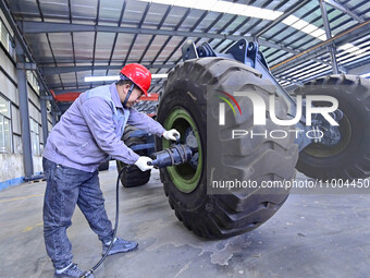 Workers are assembling at a workshop of a machinery and equipment manufacturing enterprise in Qingzhou, East China's Shandong province, on F...