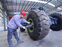 Workers are assembling at a workshop of a machinery and equipment manufacturing enterprise in Qingzhou, East China's Shandong province, on F...