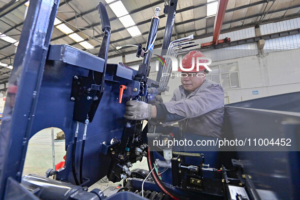 Workers are assembling at a workshop of a machinery and equipment manufacturing enterprise in Qingzhou, East China's Shandong province, on F...