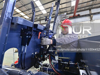 Workers are assembling at a workshop of a machinery and equipment manufacturing enterprise in Qingzhou, East China's Shandong province, on F...