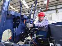 Workers are assembling at a workshop of a machinery and equipment manufacturing enterprise in Qingzhou, East China's Shandong province, on F...