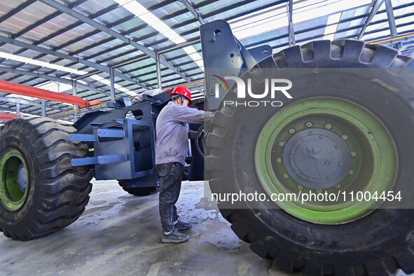 Workers are assembling at a workshop of a machinery and equipment manufacturing enterprise in Qingzhou, East China's Shandong province, on F...