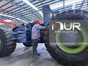 Workers are assembling at a workshop of a machinery and equipment manufacturing enterprise in Qingzhou, East China's Shandong province, on F...