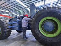 Workers are assembling at a workshop of a machinery and equipment manufacturing enterprise in Qingzhou, East China's Shandong province, on F...