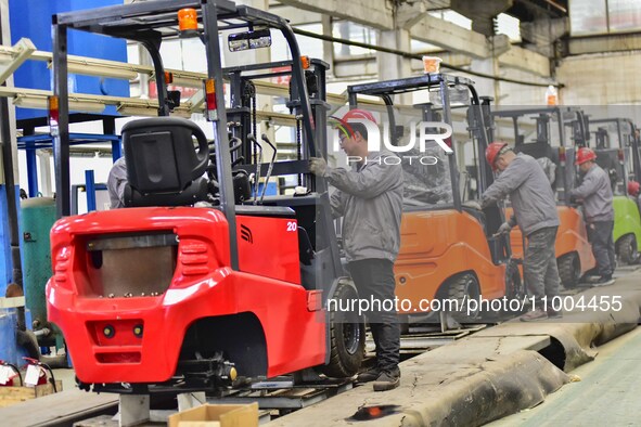 Workers are assembling at a workshop of a machinery and equipment manufacturing enterprise in Qingzhou, East China's Shandong province, on F...