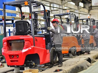 Workers are assembling at a workshop of a machinery and equipment manufacturing enterprise in Qingzhou, East China's Shandong province, on F...