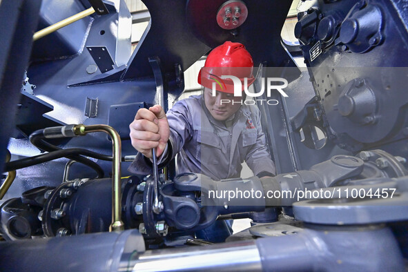 Workers are assembling at a workshop of a machinery and equipment manufacturing enterprise in Qingzhou, East China's Shandong province, on F...