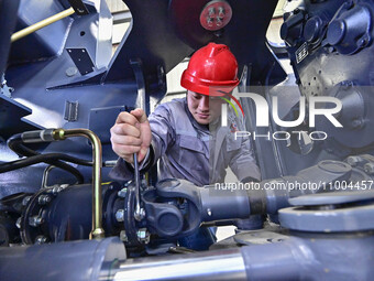 Workers are assembling at a workshop of a machinery and equipment manufacturing enterprise in Qingzhou, East China's Shandong province, on F...