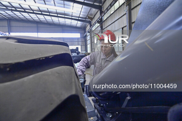 Workers are assembling at a workshop of a machinery and equipment manufacturing enterprise in Qingzhou, East China's Shandong province, on F...