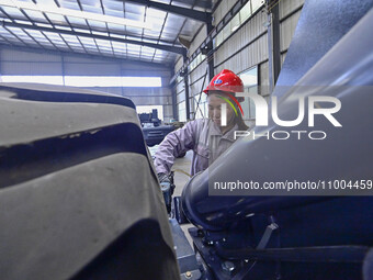 Workers are assembling at a workshop of a machinery and equipment manufacturing enterprise in Qingzhou, East China's Shandong province, on F...