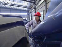 Workers are assembling at a workshop of a machinery and equipment manufacturing enterprise in Qingzhou, East China's Shandong province, on F...