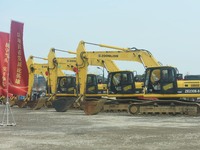 Construction workers are driving an excavator to start construction of the main campus of the Hangzhou Institute for Advanced Studies at the...