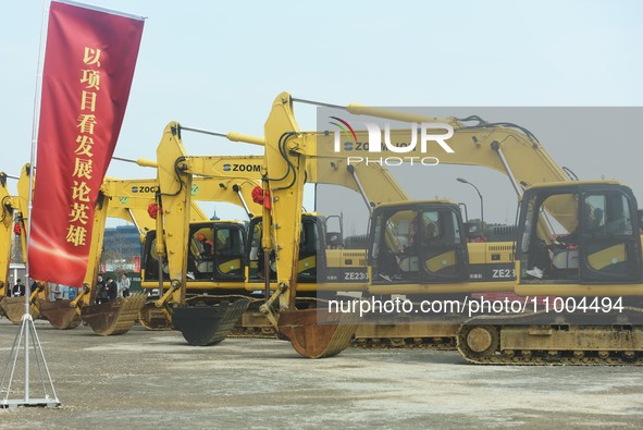 Construction workers are driving an excavator to start construction of the main campus of the Hangzhou Institute for Advanced Studies at the...