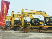 Construction workers are driving an excavator to start construction of the main campus of the Hangzhou Institute for Advanced Studies at the...