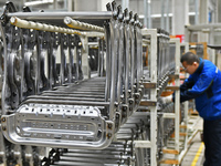 A worker is conducting a product quality inspection at a workshop of an auto parts company in Yantai, China, on February 18, 2024. (