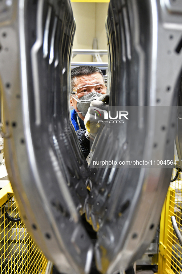 A worker is working on the production line at a workshop of an auto parts company in Yantai, China, on February 18, 2024. 