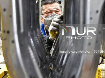 A worker is working on the production line at a workshop of an auto parts company in Yantai, China, on February 18, 2024. (