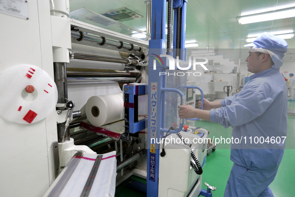 A worker is working in a production workshop at a pharmaceutical packaging company in Lianyungang, China, on February 18, 2024. 