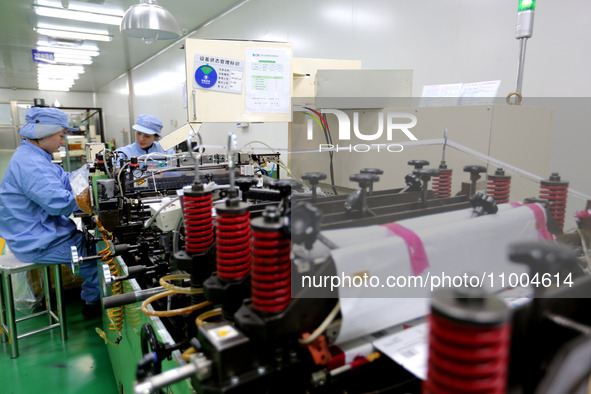 A worker is working in a production workshop at a pharmaceutical packaging company in Lianyungang, China, on February 18, 2024. 