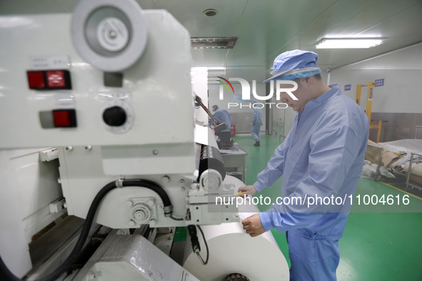 A worker is working in a production workshop at a pharmaceutical packaging company in Lianyungang, China, on February 18, 2024. 