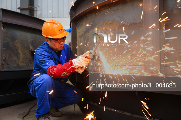 Workers are polishing at the production workshop of Nanjing Changjiang Industrial Furnace Technology Group Co., Ltd. in Nanjing, Jiangsu pro...