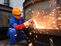 Workers are polishing at the production workshop of Nanjing Changjiang Industrial Furnace Technology Group Co., Ltd. in Nanjing, Jiangsu pro...