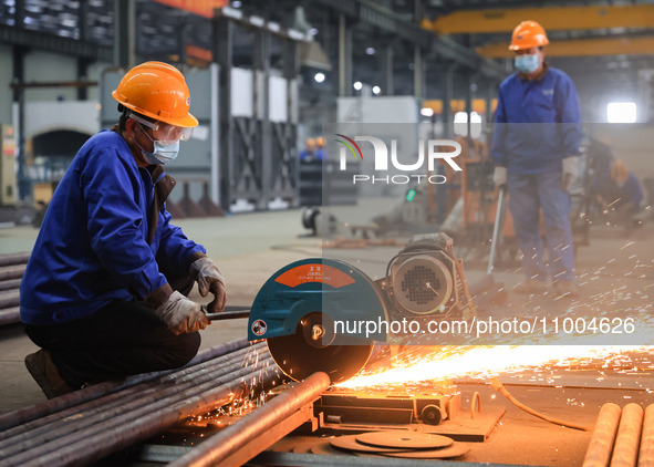 A worker is performing cutting operations at the production workshop of Nanjing Changjiang Industrial Furnace Technology Group Co., Ltd. in...