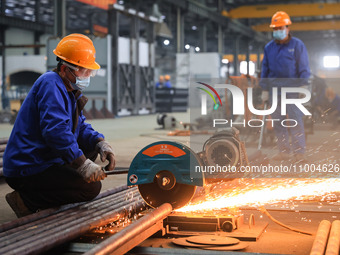 A worker is performing cutting operations at the production workshop of Nanjing Changjiang Industrial Furnace Technology Group Co., Ltd. in...