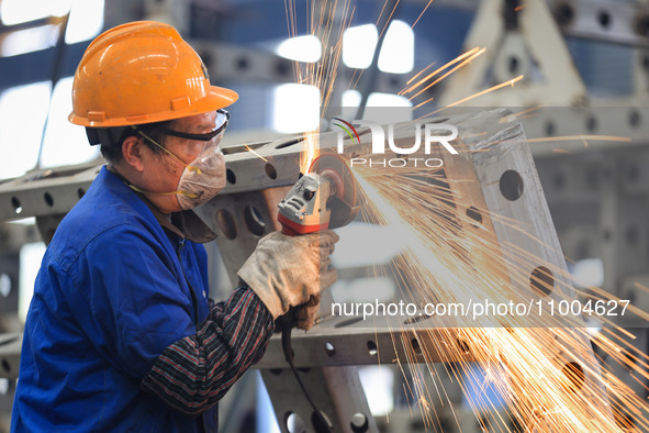 A worker is grinding at the production workshop of Nanjing Changjiang Industrial Furnace Technology Group Co., Ltd. in Nanjing, Jiangsu Prov...