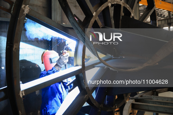 A worker is performing welding at the production workshop of Nanjing Changjiang Industrial Furnace Technology Group Co., Ltd. in Nanjing, Ji...