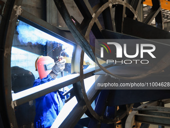 A worker is performing welding at the production workshop of Nanjing Changjiang Industrial Furnace Technology Group Co., Ltd. in Nanjing, Ji...