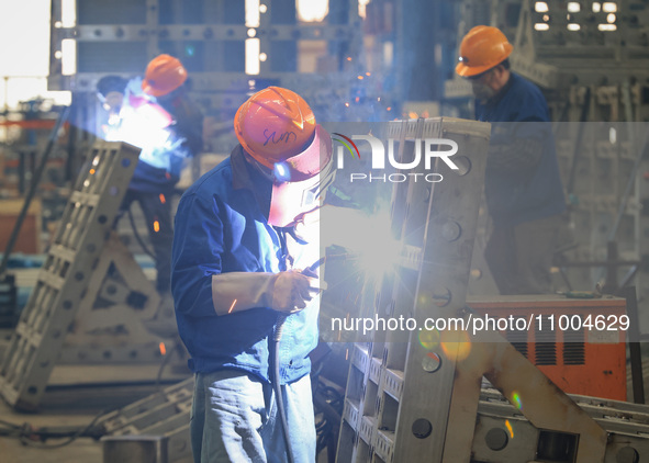 Workers are performing welding at the production workshop of Nanjing Changjiang Industrial Furnace Technology Group Co., Ltd. in Nanjing, Ji...