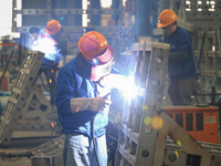 Workers are performing welding at the production workshop of Nanjing Changjiang Industrial Furnace Technology Group Co., Ltd. in Nanjing, Ji...